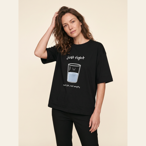 Studio portrait in the Black adult tee, white ink print.