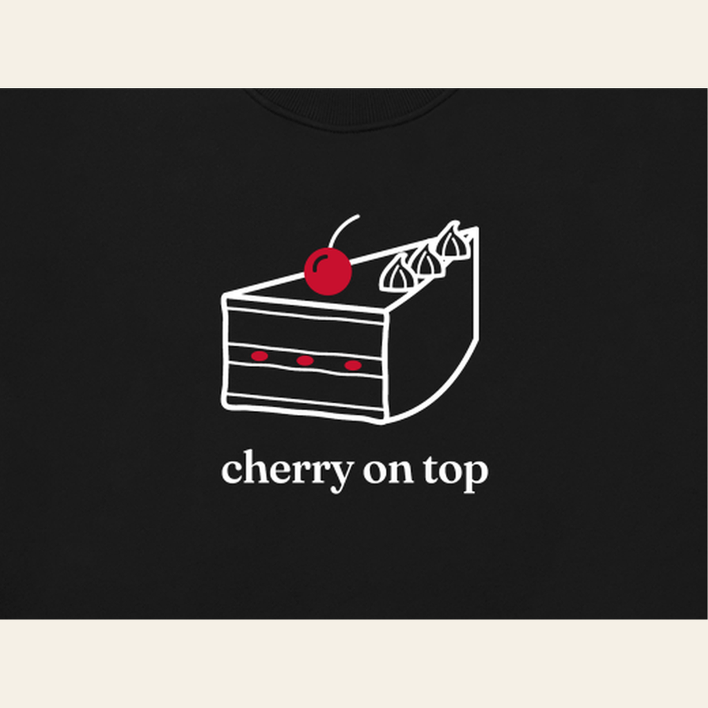 Close-up of the Cherry on Top mark printed on the Black sweatshirt