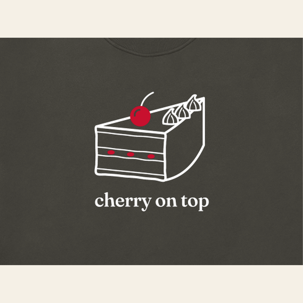 Close-up of the Cherry on Top mark printed on the Dark Gray sweatshirt