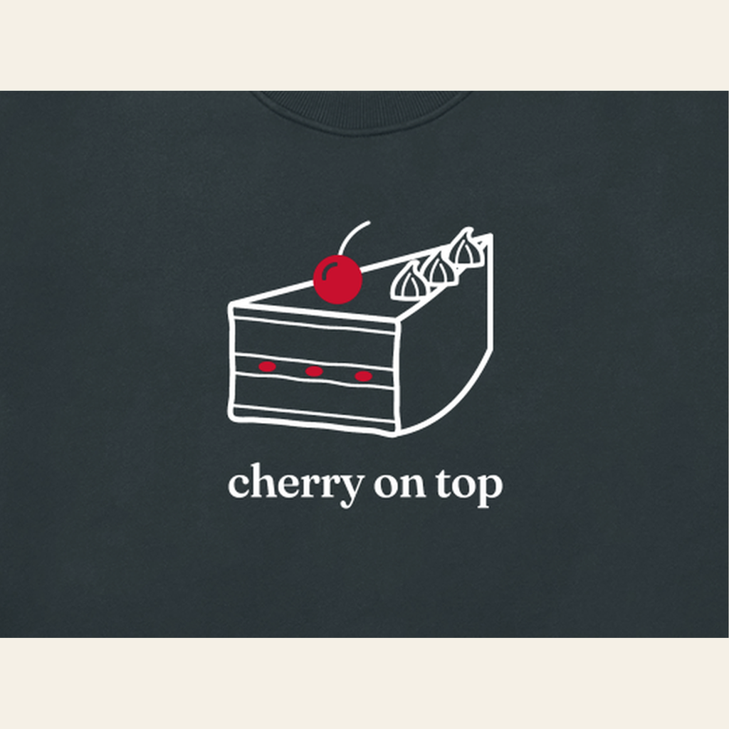 Close-up of the Cherry on Top mark printed on the Navy Blue sweatshirt
