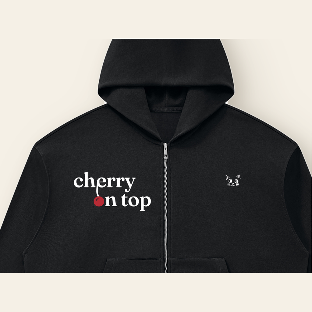 Close-up of the Cherry on Top mark printed on the Black zip hoodie