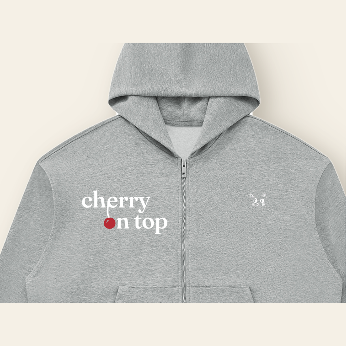 Close-up of the Cherry on Top mark printed on the Heather Gray zip hoodie